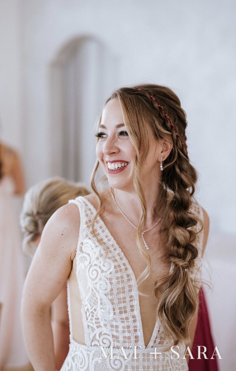 A bride smiling as she gets ready